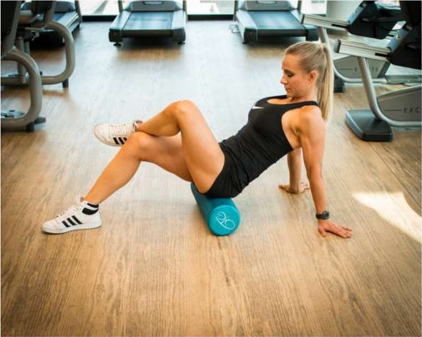 Foam rolling the glutes to relieve lower back tension