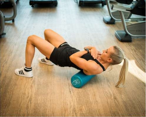 Foam rolling the upper back to release tight muscles
