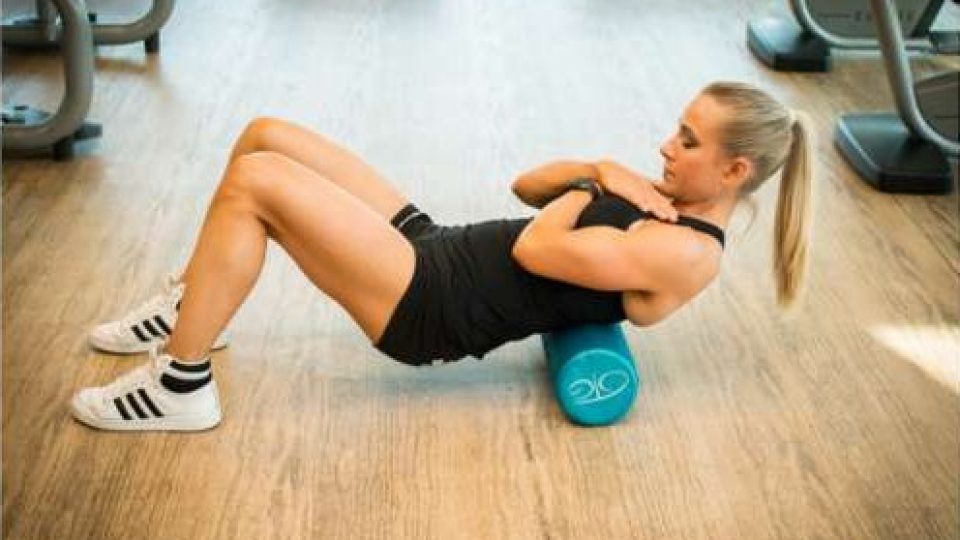 Foam rolling the mid back with hips lifted